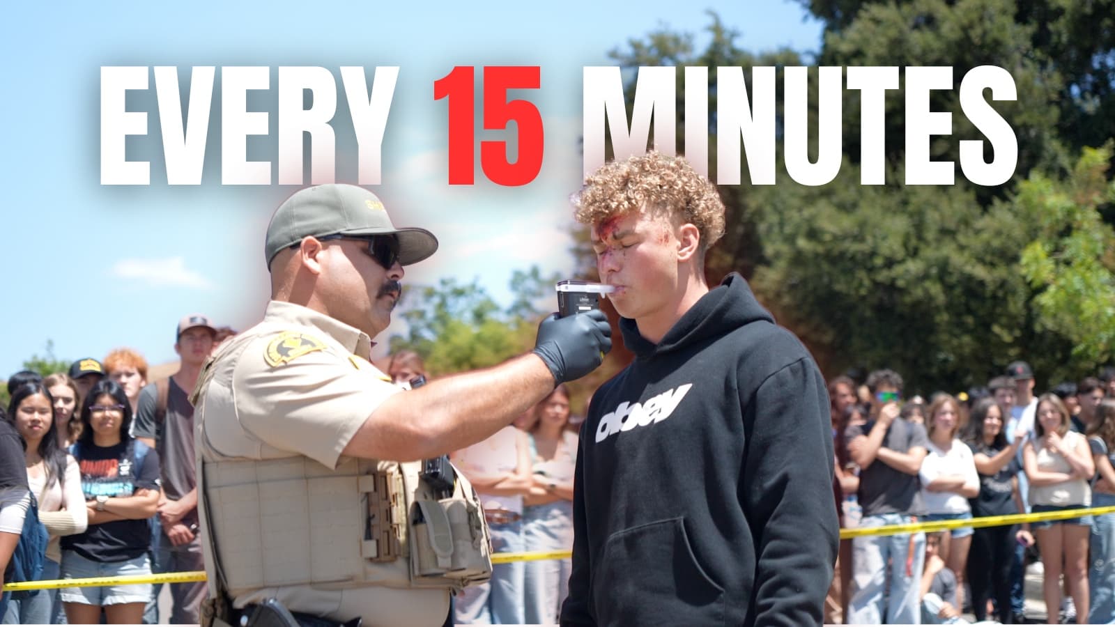 A law-enforcement officer administering a staged breath test during Yucaipa High School's Every 15 Minutes reenactment